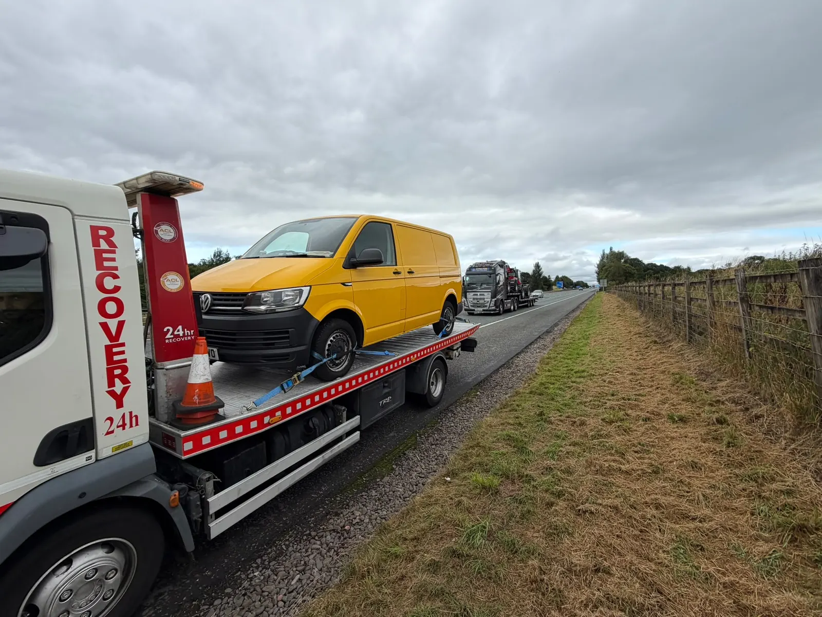 Yellow van on recovery truck